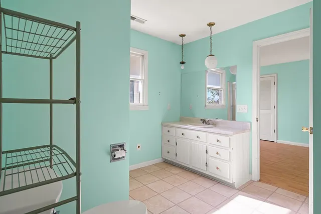 a bathroom with a mirror a sink and a mirror