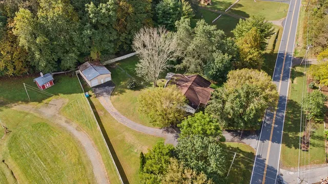 an aerial view of residential houses with outdoor space and river