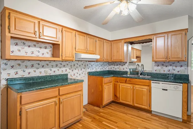 a kitchen with stainless steel appliances granite countertop a sink and cabinets