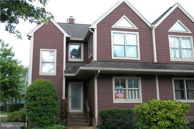771 Bellefield Road, Unit 133 Dowell, MD 20629 - Photo 1 of 24 a view of a brick house with large windows and a small yard