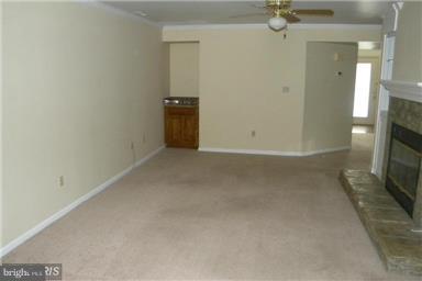 771 Bellefield Road, Unit 133 Dowell, MD 20629 - Photo 12 of 24 a view of a livingroom with wooden floor and a fireplace
