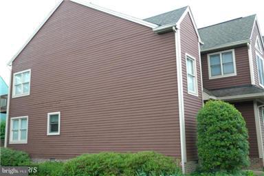 771 Bellefield Road, Unit 133 Dowell, MD 20629 - Photo 3 of 24 a view of a house with a yard and garage