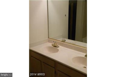 771 Bellefield Road, Unit 133 Dowell, MD 20629 - Photo 21 of 24 a bathroom with a sink and a mirror