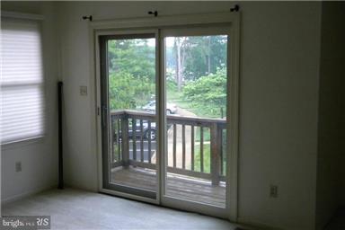 771 Bellefield Road, Unit 133 Dowell, MD 20629 - Photo 23 of 24 a view of an empty room with a balcony