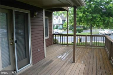 771 Bellefield Road, Unit 133 Dowell, MD 20629 - Photo 4 of 24 a view of balcony with wooden floor