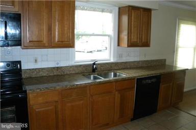 771 Bellefield Road, Unit 133 Dowell, MD 20629 - Photo 7 of 24 a kitchen with a sink and cabinets