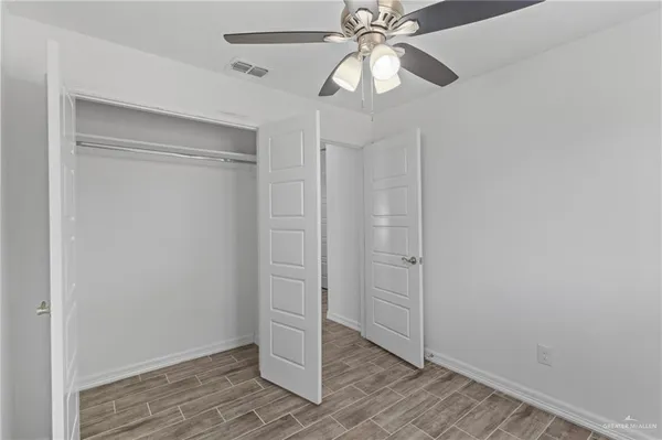 an empty room with wooden floor and door