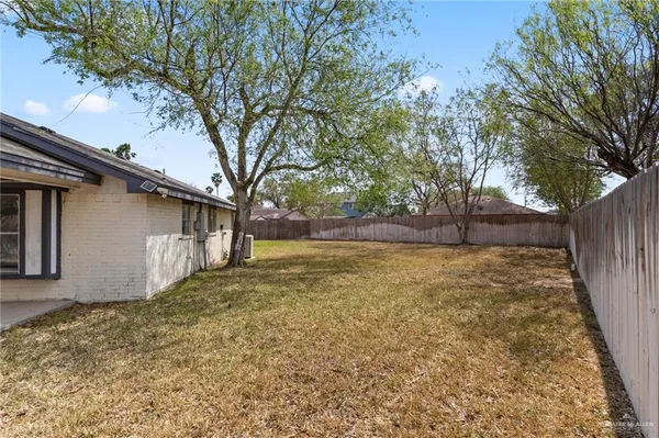 a view of backyard of house with green space