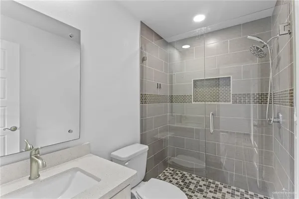 a bathroom with a shower a toilet and a sink