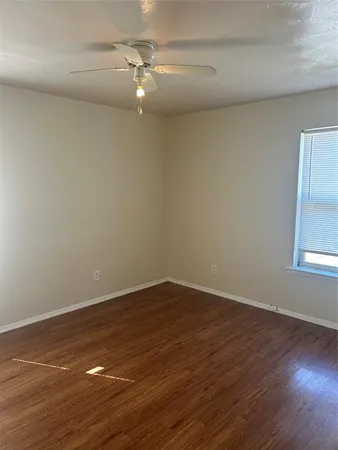 a view of a room with wooden floor and fan