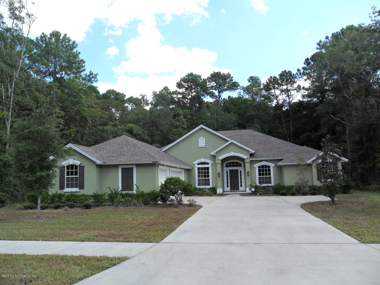 97202 Bluff View Circle, Unit LOT 38 ROSES BLUFF Yulee, FL 32097 - Photo 1 of 14 a front view of a house with a yard
