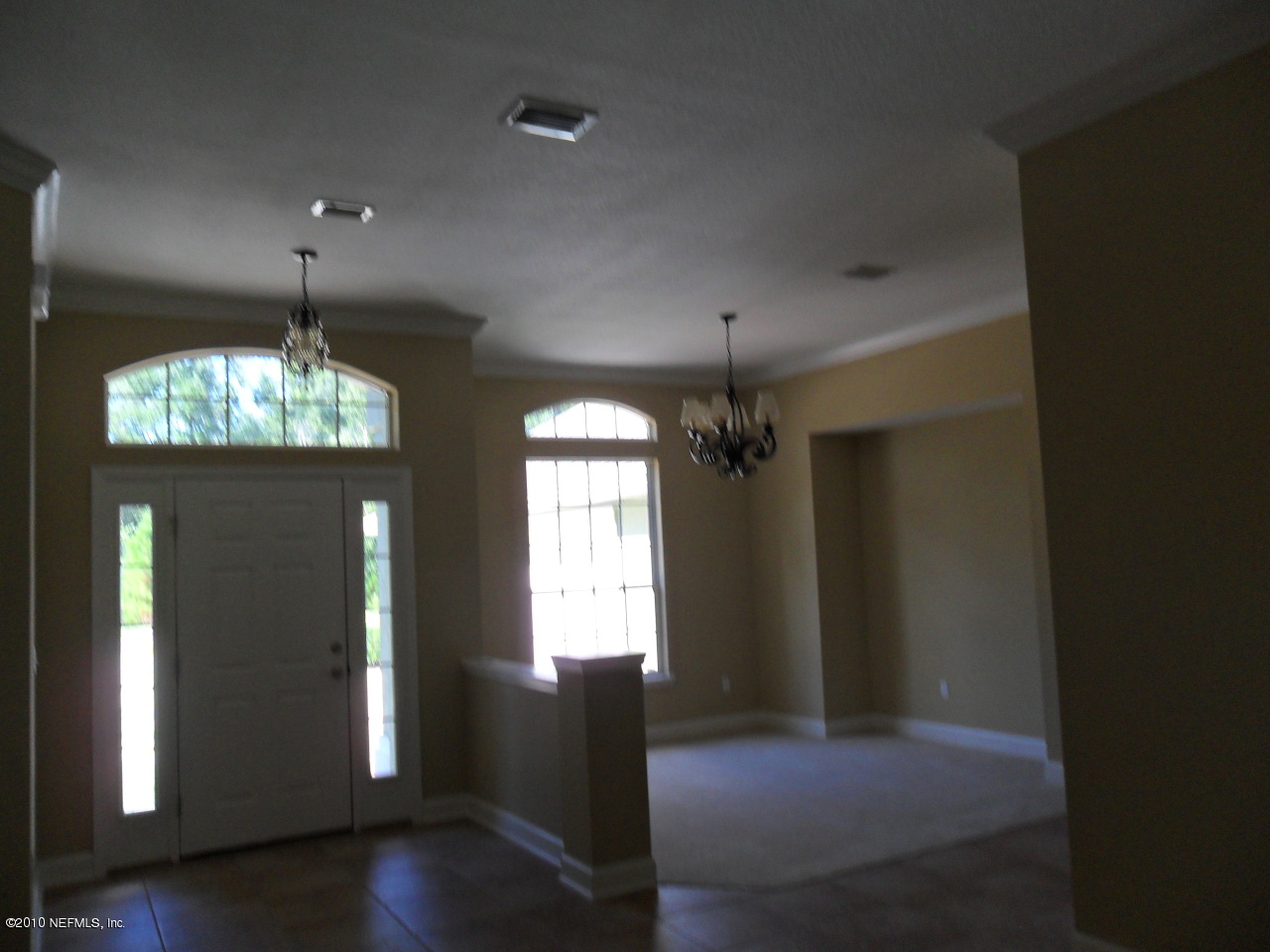 97202 Bluff View Circle, Unit LOT 38 ROSES BLUFF Yulee, FL 32097 - Photo 2 of 14 an empty room with wooden floor chandelier and windows