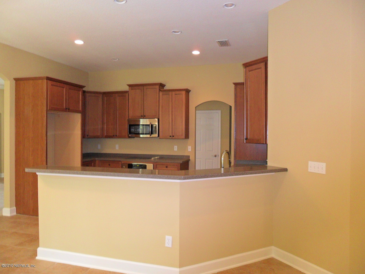 97202 Bluff View Circle, Unit LOT 38 ROSES BLUFF Yulee, FL 32097 - Photo 5 of 14 a kitchen with kitchen island a counter top space cabinets and stainless steel appliances