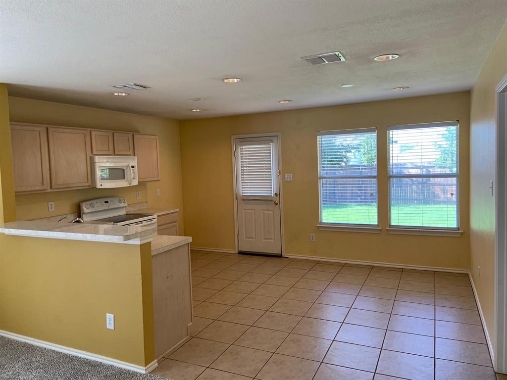 2620 Caprock Road McKinney, TX 75071 - Photo 13 of 19 Kitchen featuring white appliances, light countertops, light tile patterned floors, a peninsula, and recessed lighting