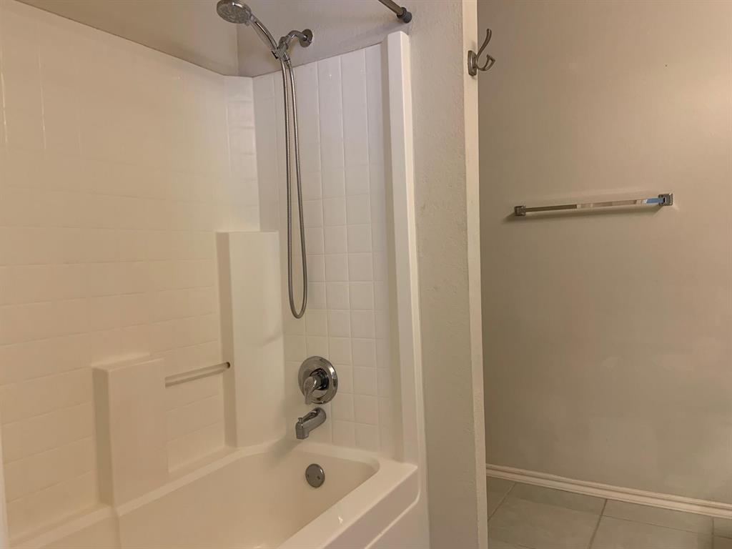 2620 Caprock Road McKinney, TX 75071 - Photo 6 of 19 Bathroom featuring shower / washtub combination and light tile patterned floors