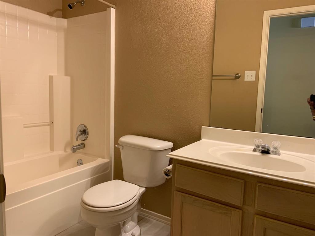 2620 Caprock Road McKinney, TX 75071 - Photo 7 of 19 Bathroom featuring a textured wall, vanity, and shower combination