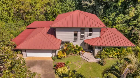 a view of a house with a yard and sitting area