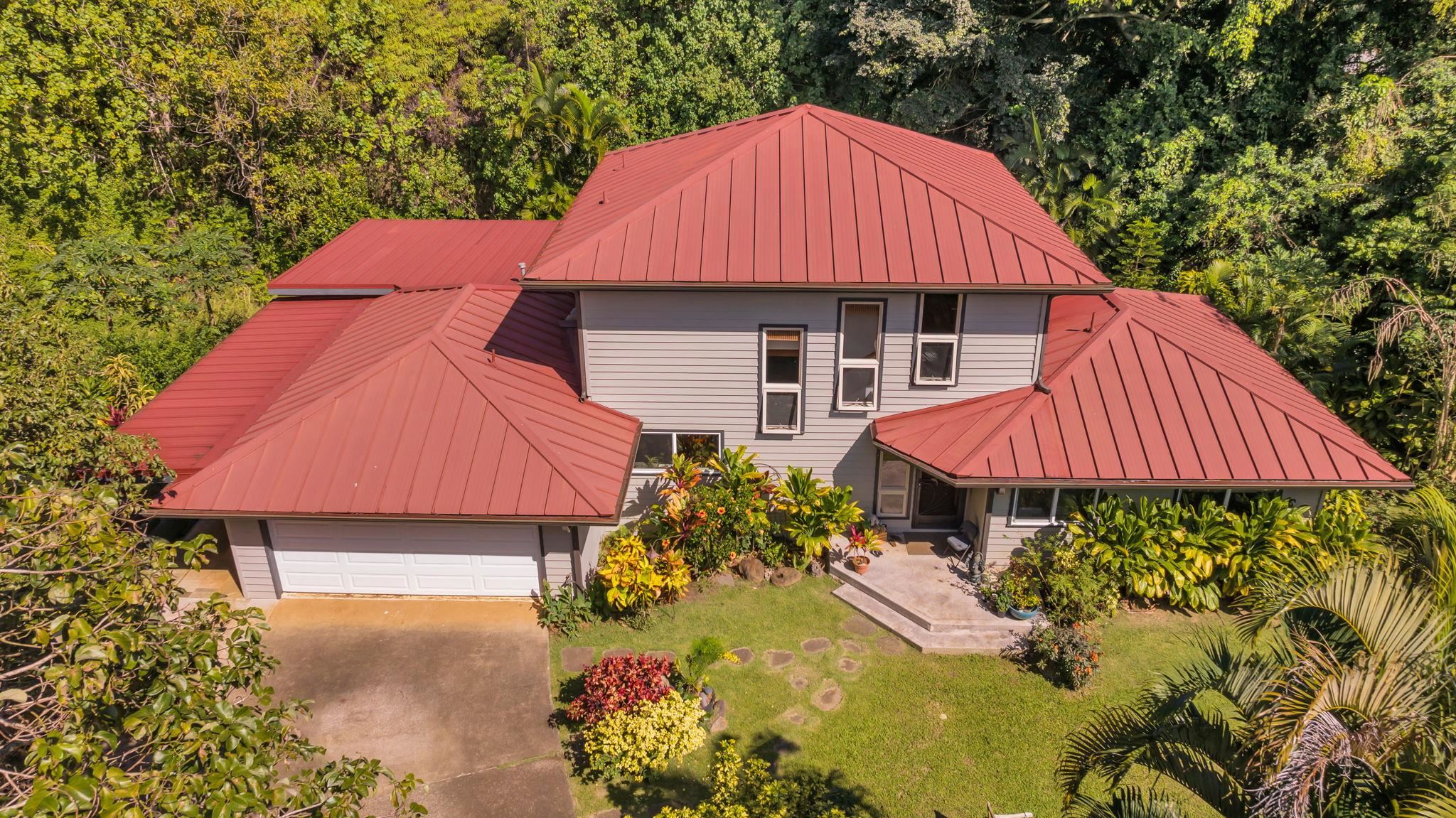 a view of a house with a yard and sitting area