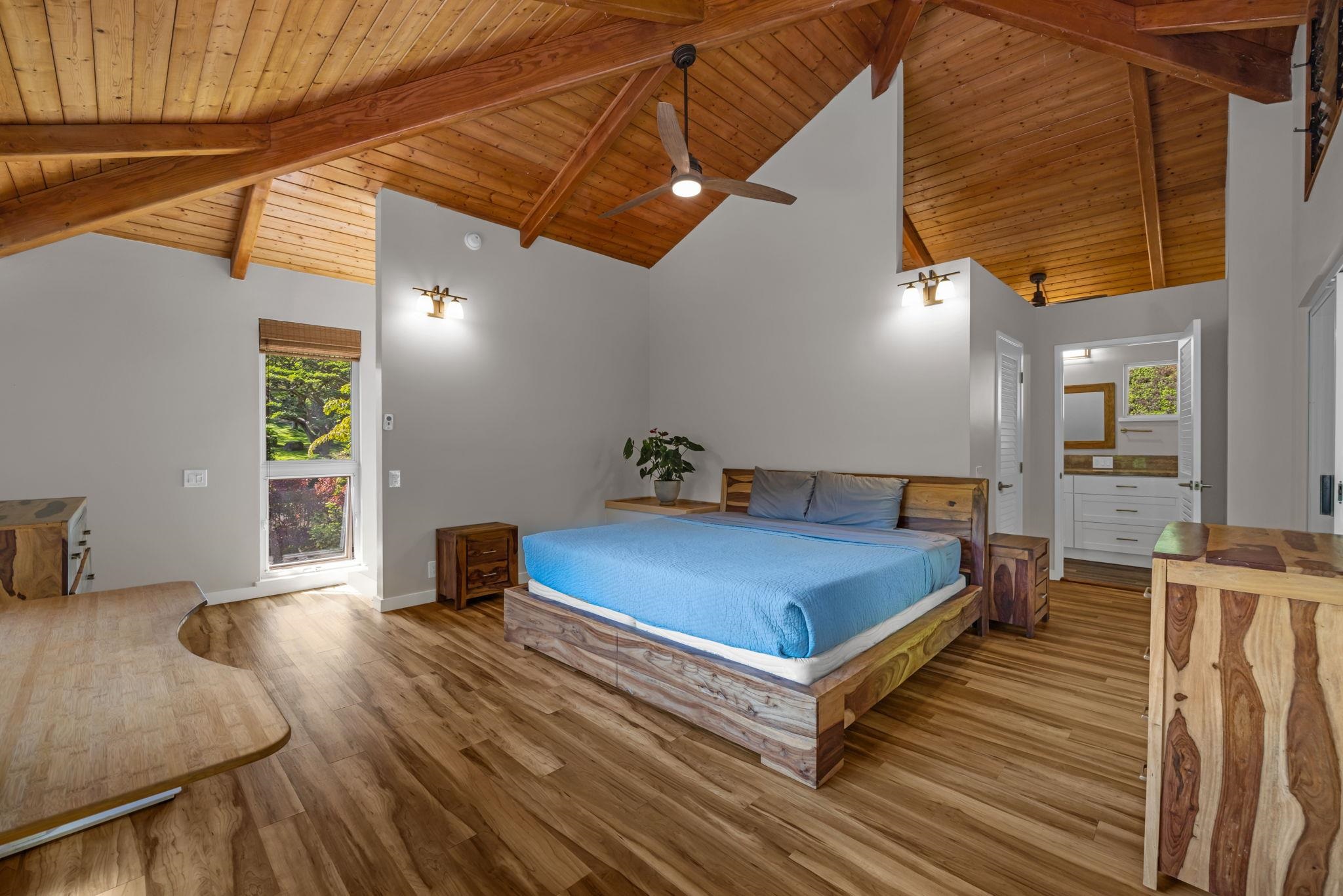 Undisclosed Address Haiku, HI 96708 - Photo 13 of 42 a spacious bedroom with a bed and wooden floor