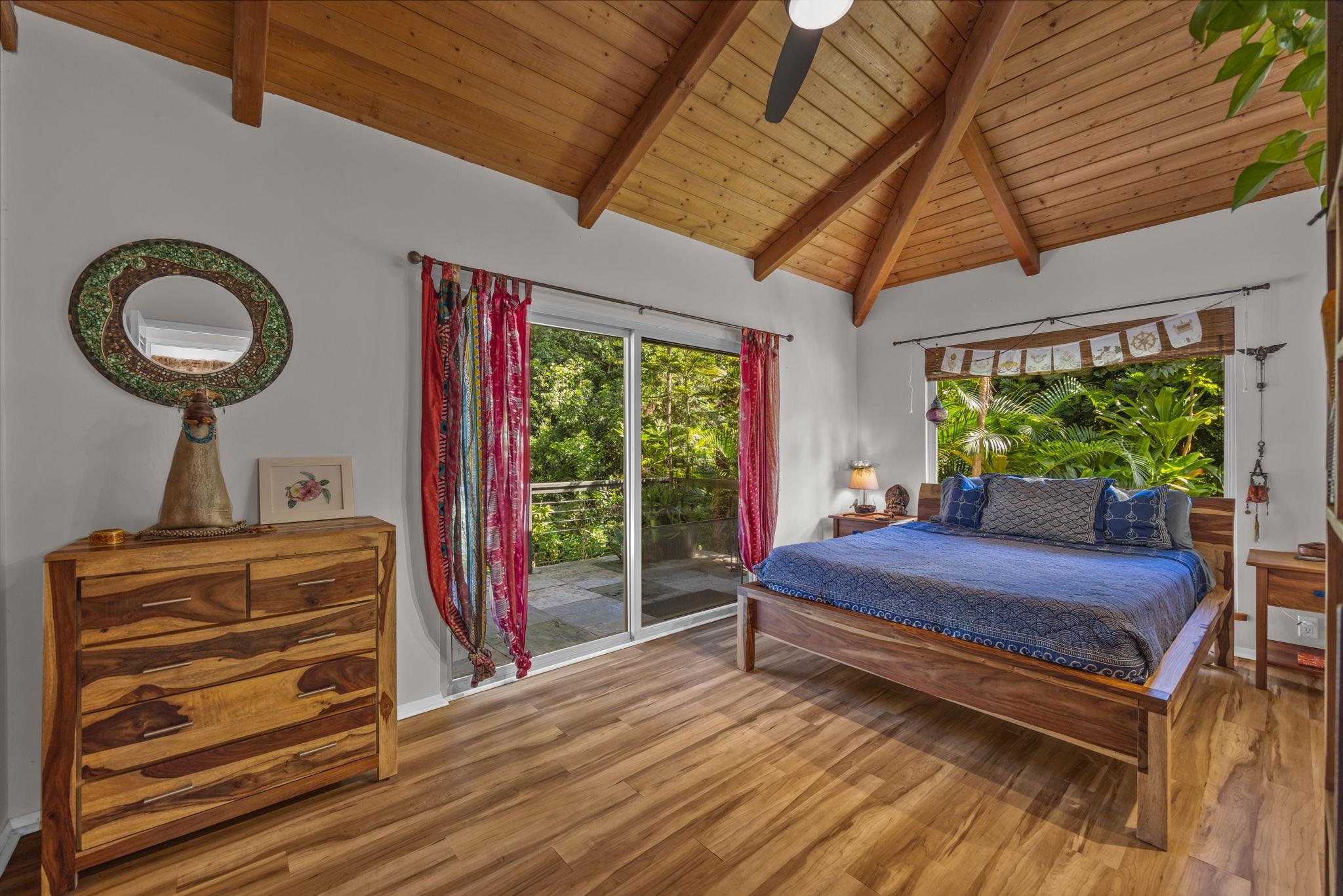 Undisclosed Address Haiku, HI 96708 - Photo 17 of 42 a bedroom with a bed and a chandelier