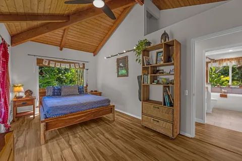 a room with painting on the wall and a potted plant