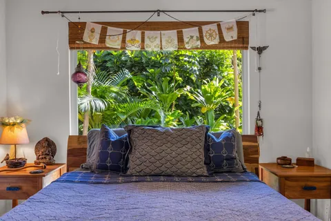 a bedroom with a bed chair and a window