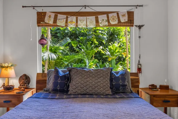 a bedroom with a bed chair and a window