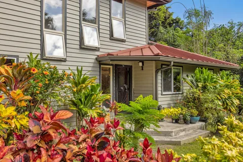 a front view of a house with a yard and fountain