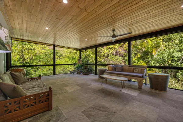 a living room with furniture and a floor to ceiling window