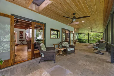 a view of a porch with chairs and a yard