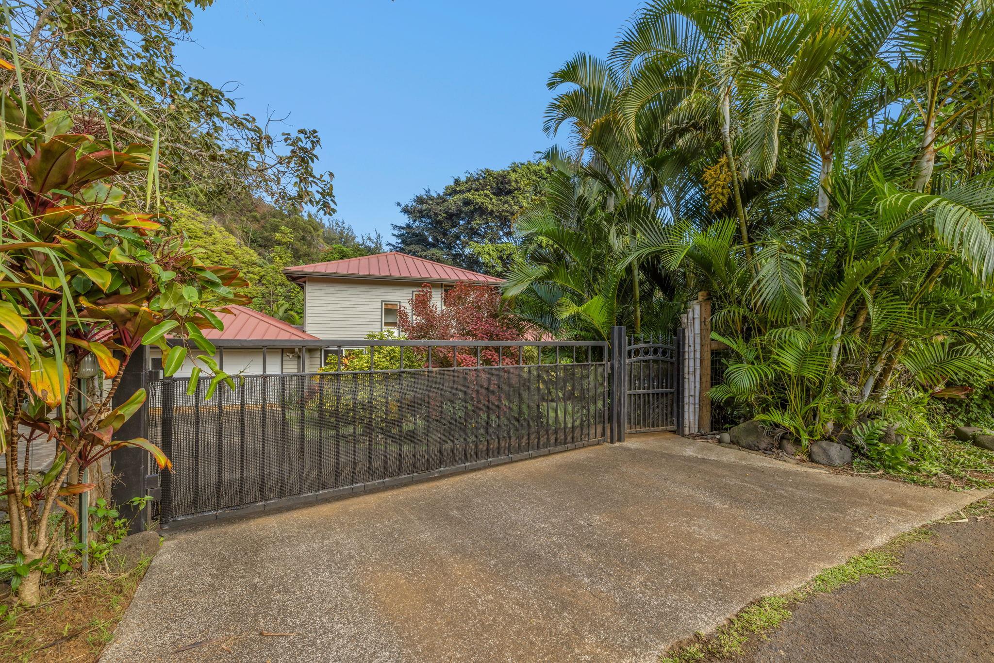Undisclosed Address Haiku, HI 96708 - Photo 29 of 42 a view of a house with a small yard and a large tree