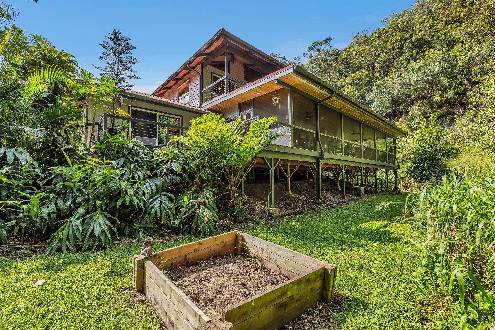 Undisclosed Address Haiku, HI 96708 - Photo 33 of 42 a front view of house with yard and trees