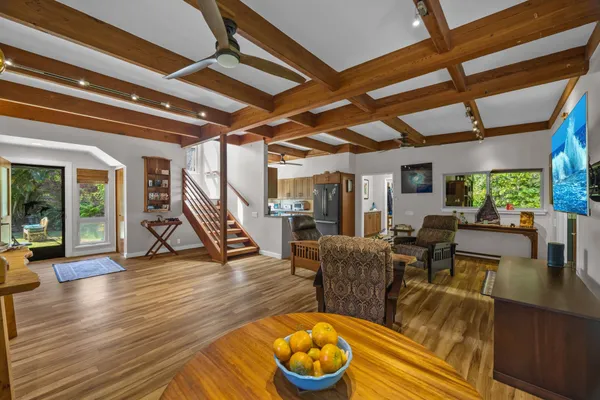 a living room with furniture and a wooden floor
