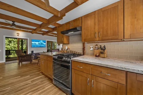 a kitchen with sink cabinets and stove top oven