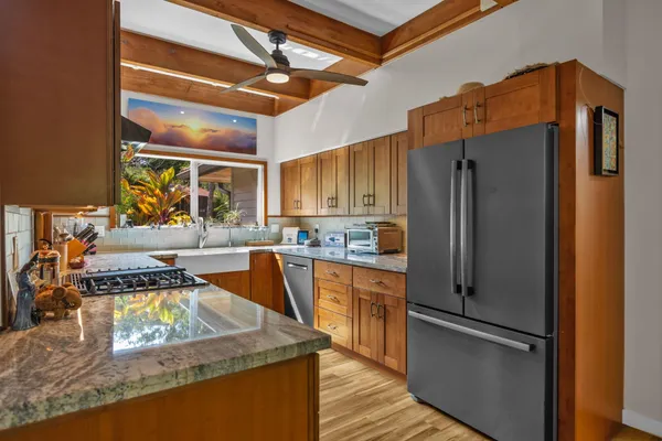 a kitchen with stainless steel appliances granite countertop a refrigerator and a sink