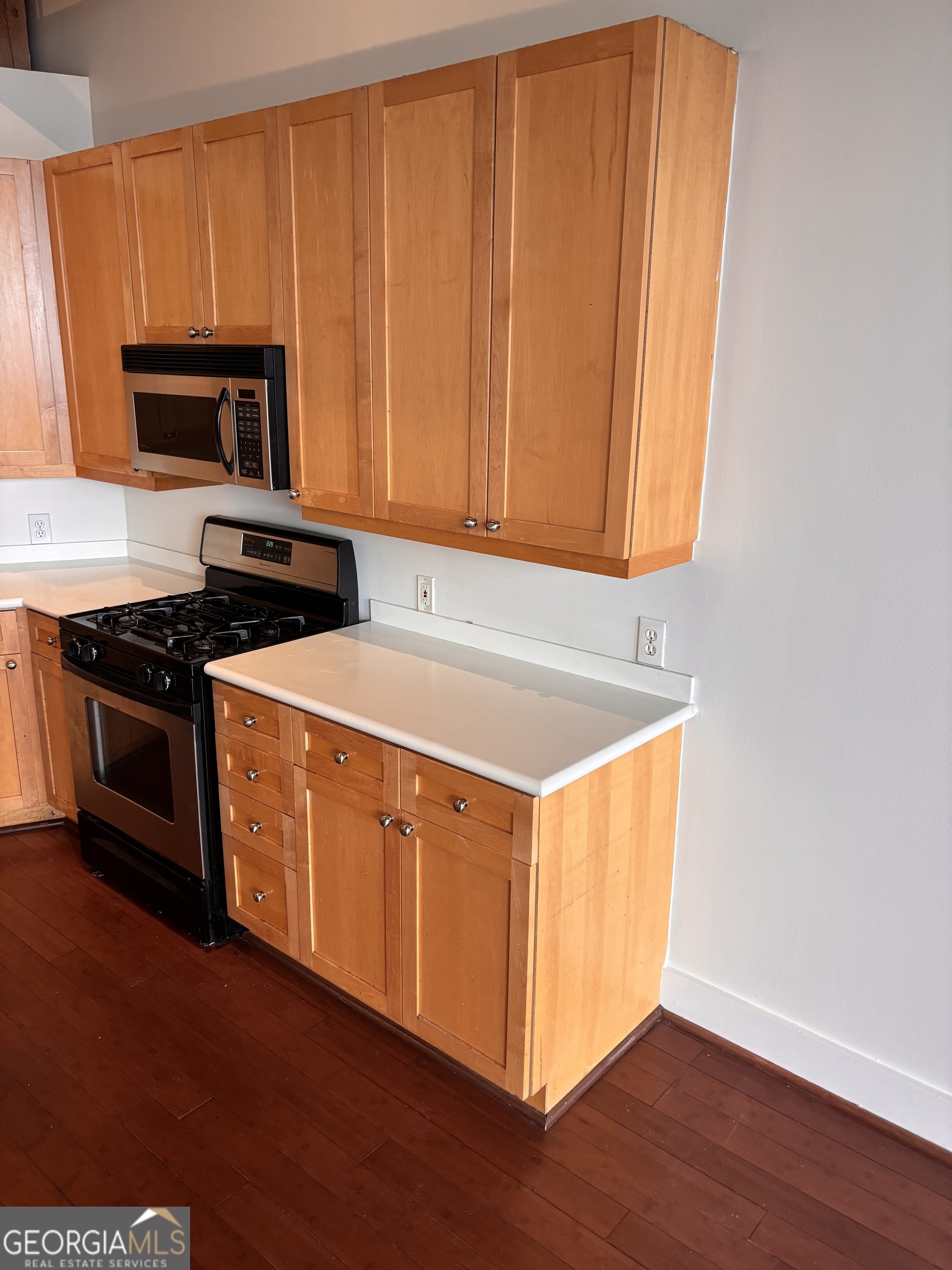204 Walker Street Southwest Atlanta, GA 30313 - Photo 14 of 43 a kitchen with stainless steel appliances granite countertop a stove a sink and a microwave