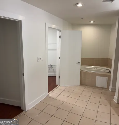 a view of a room with wooden floor and fan