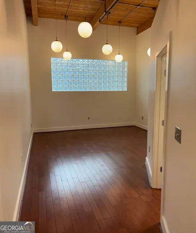 a view of a room with wooden floor and fan