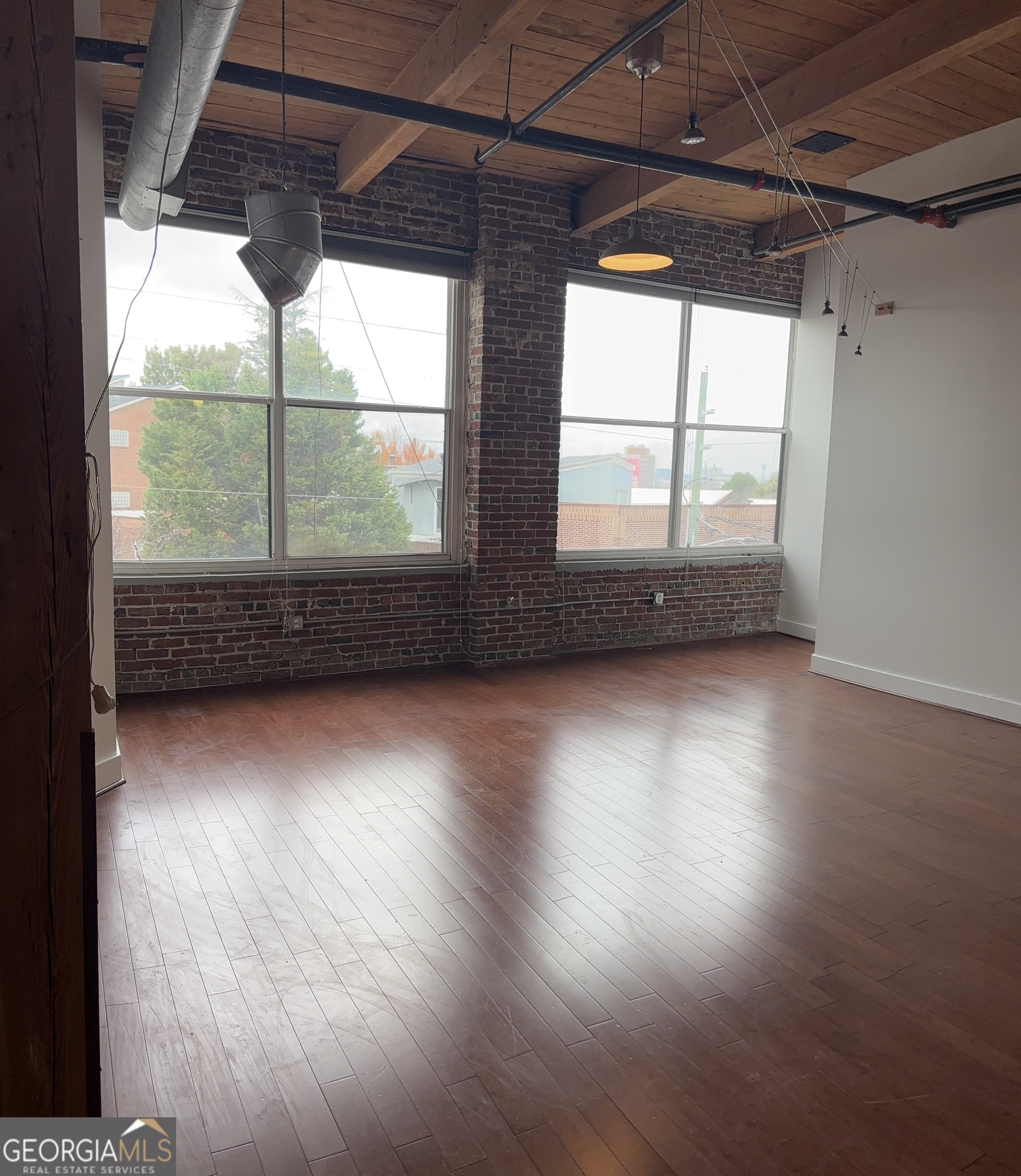 204 Walker Street Southwest Atlanta, GA 30313 - Photo 3 of 43 an empty room with wooden floor and windows