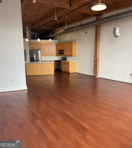 a view of a kitchen with a sink and a refrigerator