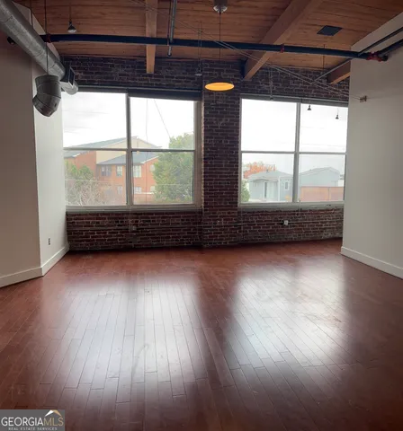 a view of a room with wooden floor