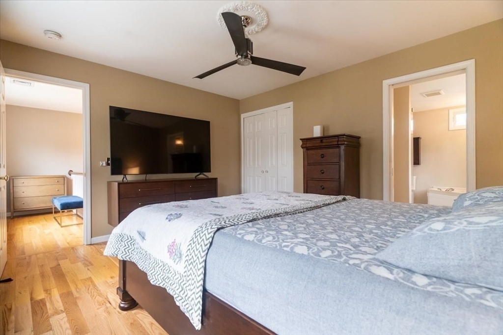 82 Hammersmith Drive Saugus, MA 01906 - Photo 22 of 42 a bedroom with a bed and a flat screen tv