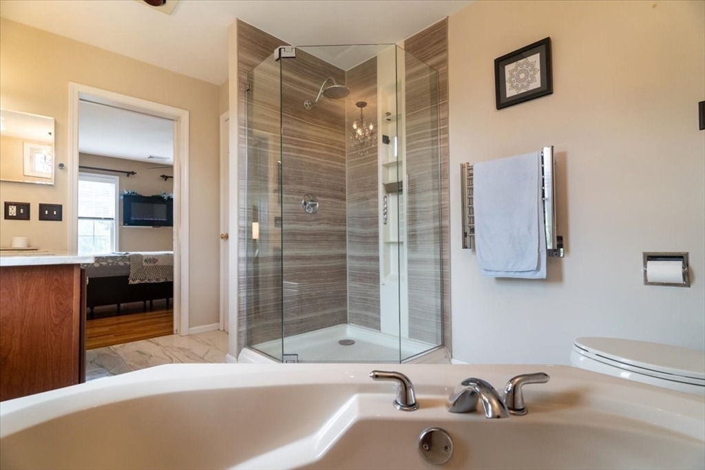 82 Hammersmith Drive Saugus, MA 01906 - Photo 25 of 42 a bathroom with a tub sink and mirror