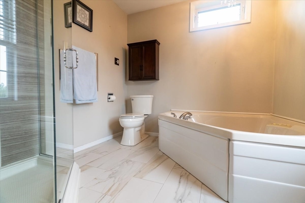 82 Hammersmith Drive Saugus, MA 01906 - Photo 26 of 42 a bathroom with a toilet sink and mirror