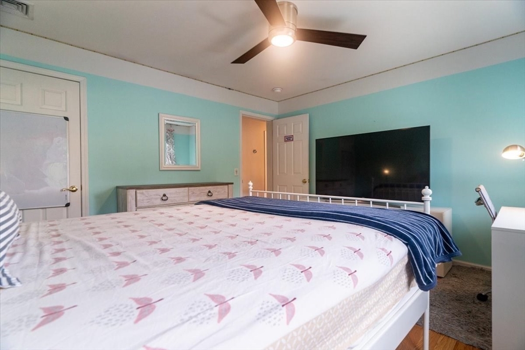82 Hammersmith Drive Saugus, MA 01906 - Photo 28 of 42 a bedroom with a large bed and a flat screen tv