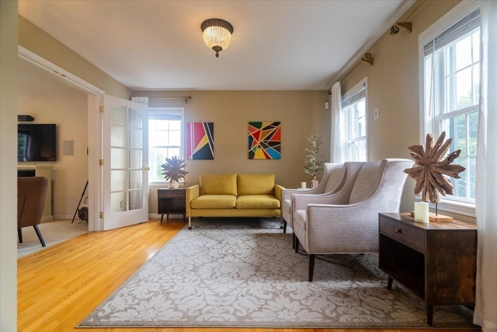 82 Hammersmith Drive Saugus, MA 01906 - Photo 3 of 42 a living room with furniture and a flat screen tv