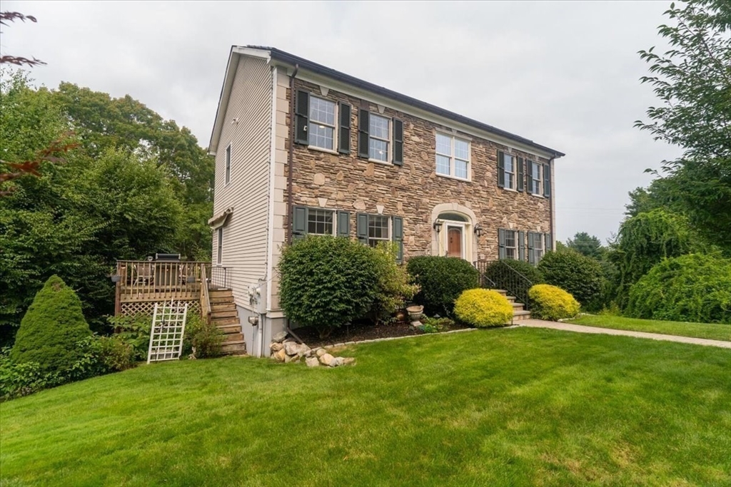 82 Hammersmith Drive Saugus, MA 01906 - Photo 34 of 42 a front view of a house with garden and trees