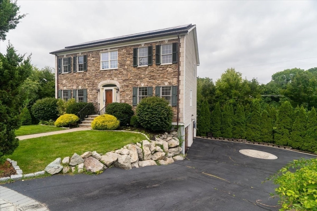 82 Hammersmith Drive Saugus, MA 01906 - Photo 36 of 42 a front view of a house with a yard and garage