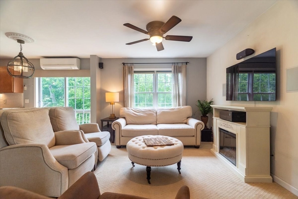 82 Hammersmith Drive Saugus, MA 01906 - Photo 6 of 42 a living room with furniture a large window and a chandelier