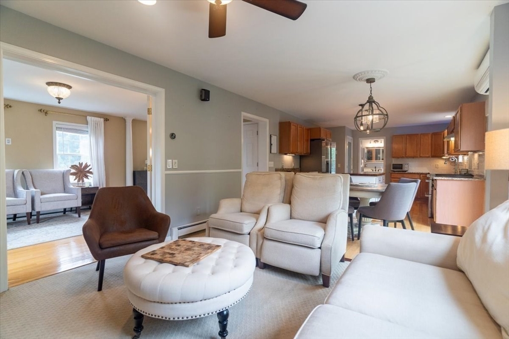 82 Hammersmith Drive Saugus, MA 01906 - Photo 7 of 42 a living room with furniture and a chandelier